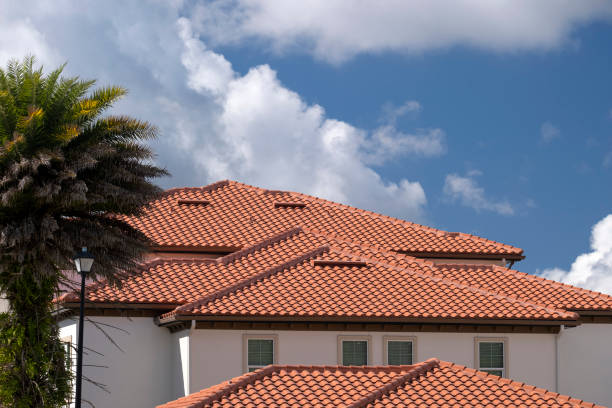 Closeup of house rooftop covered with ceramic shingles. Tiled covering of building.
